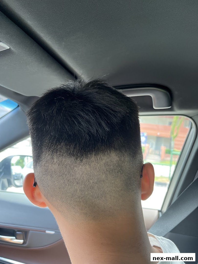 A person's head with a fresh fade haircut, showing the back and side of their head.