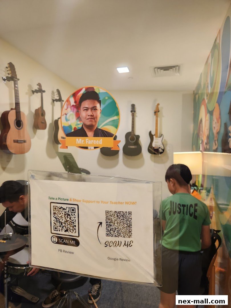A music academy interior with guitars on the wall and students practicing.