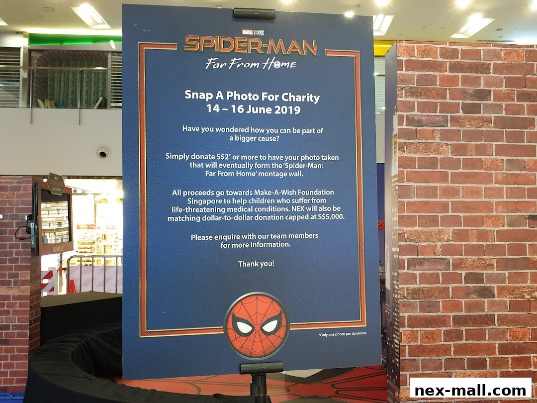 A sign promoting a Spider-Man charity photo event with donation details.