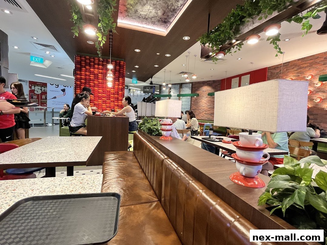 Interior view of The Hainan Story Coffee House Nex with diners and decorative elements.
