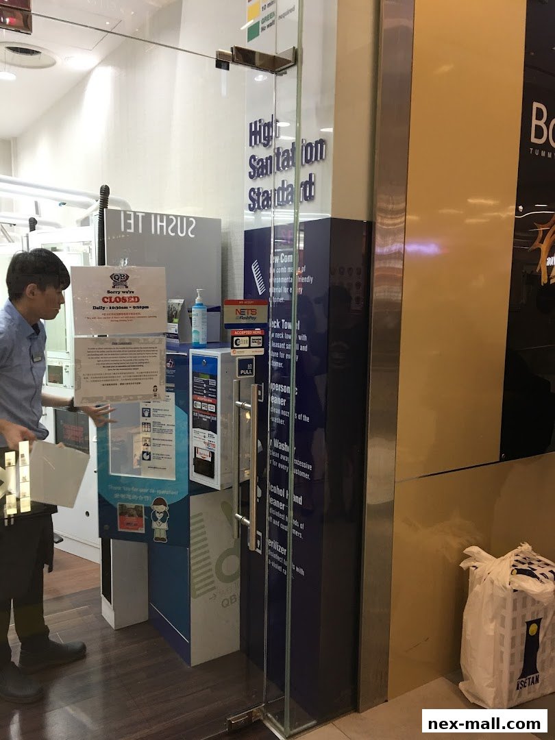 A shop entrance with a 'Closed' sign and sanitation information displayed.