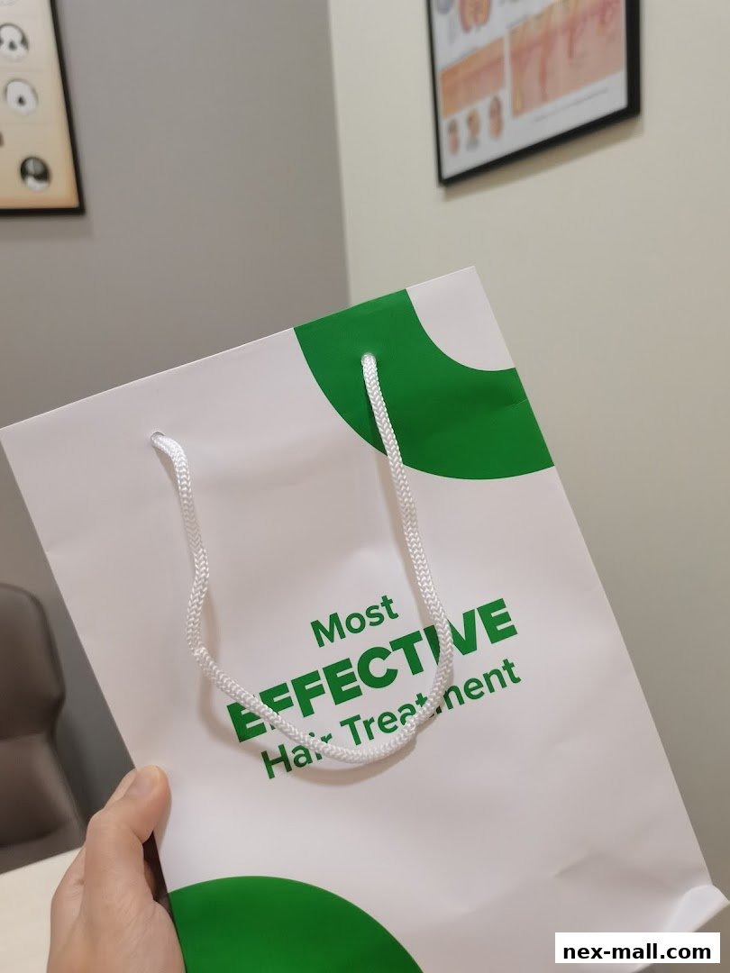 A hand holds a white shopping bag with green accents and text about hair treatment.