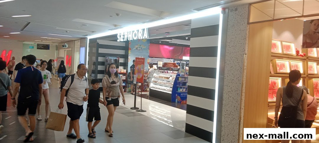 People walking past a Sephora store entrance with displays of beauty products inside.