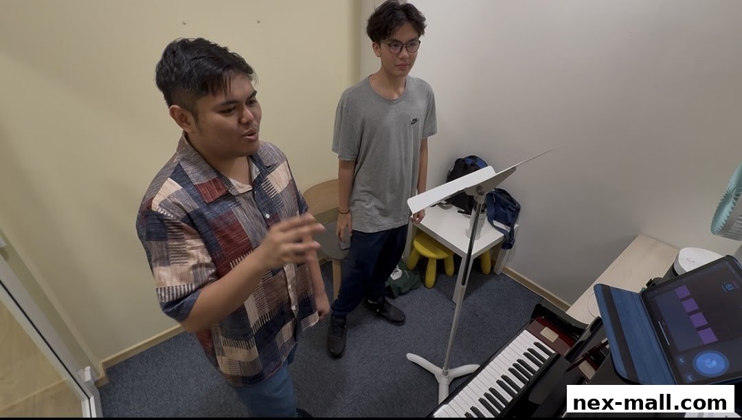 A music instructor teaches a student in a room with a piano and tablet.