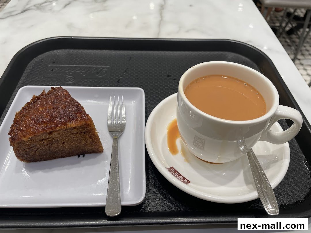 A slice of cake and a cup of tea served on a tray at Toast Box.