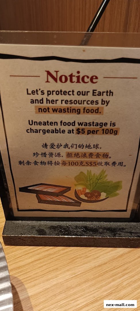 A notice about food wastage with a charge of $5 per 100g, featuring illustrations of food.
