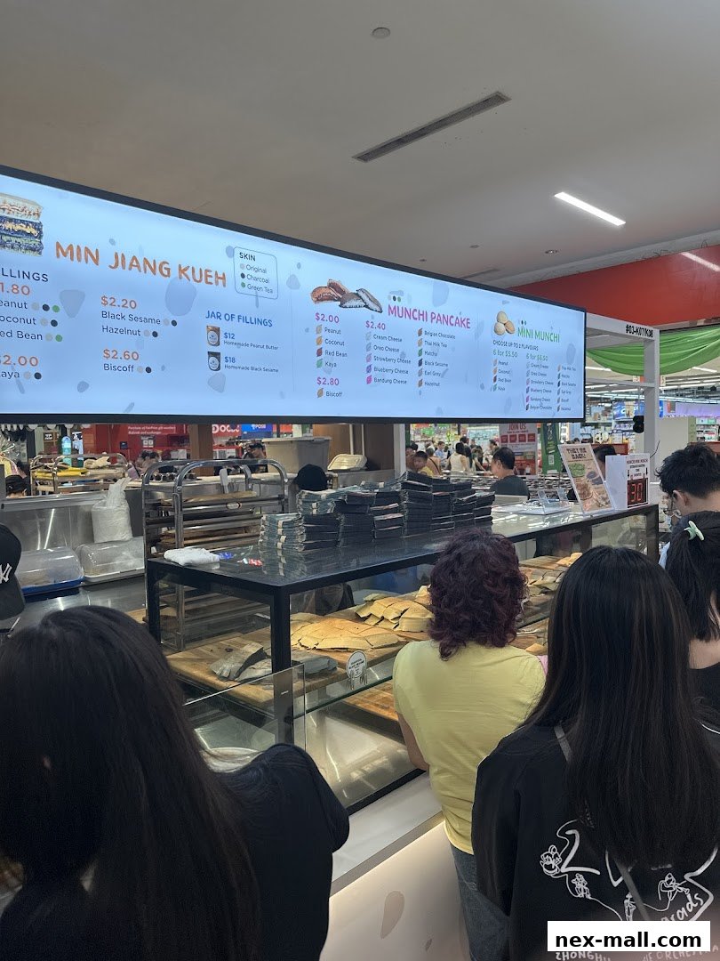 A brightly lit menu board displays various pancake flavors and fillings at Munchi Pancakes.