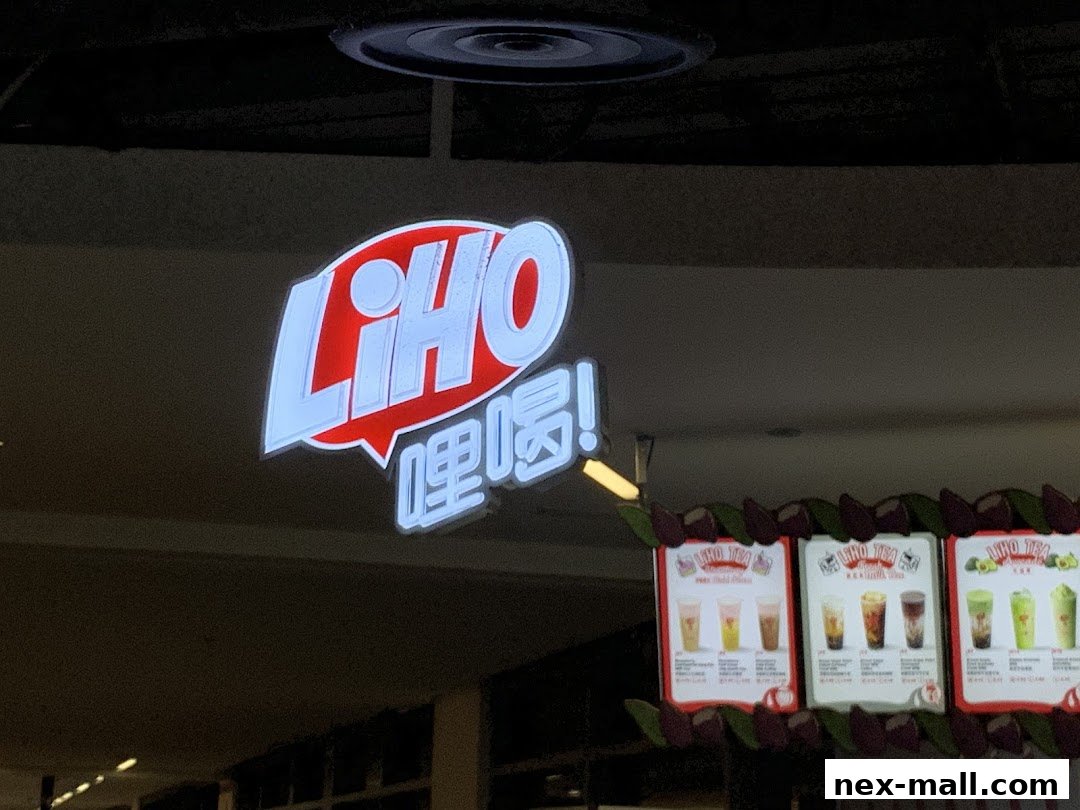 A LiHO TEA sign with a menu display showing various drinks.