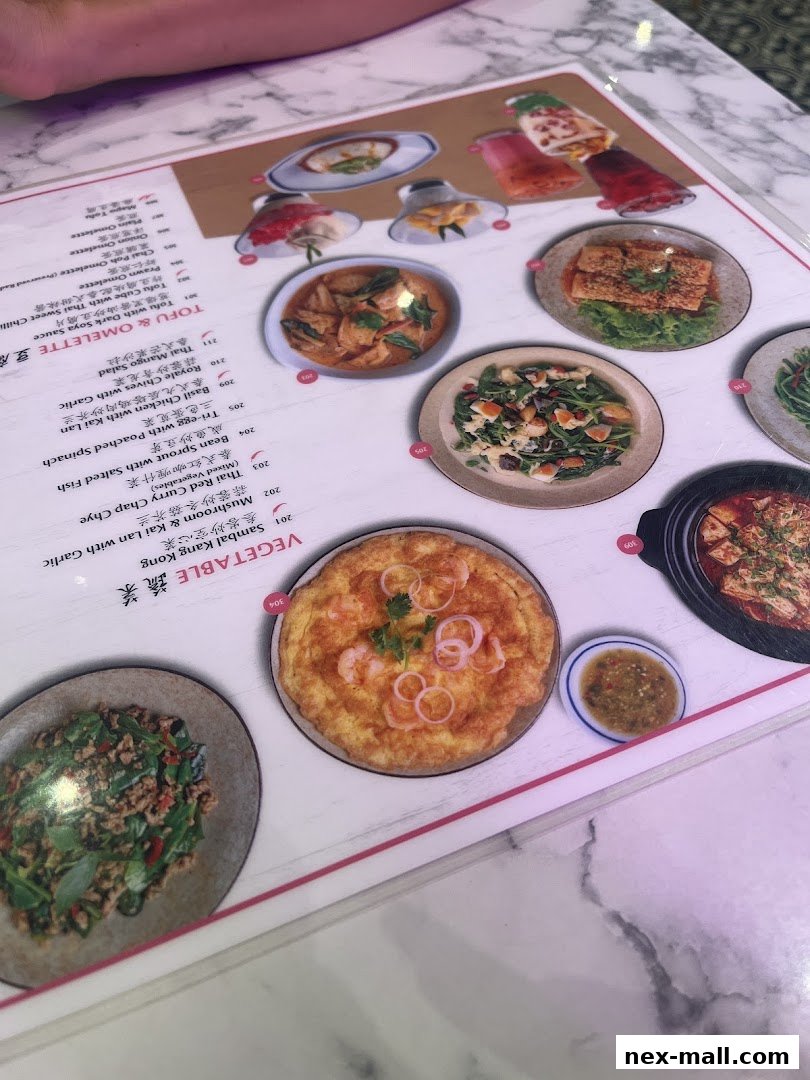 A menu from Go-Ang Pratunam Chicken Rice featuring various Thai dishes with images.