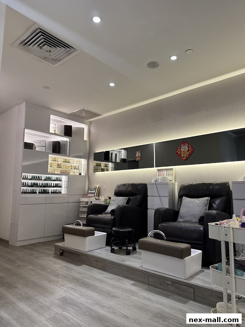 Interior of a beauty salon with pedicure chairs, nail polish display, and modern decor.