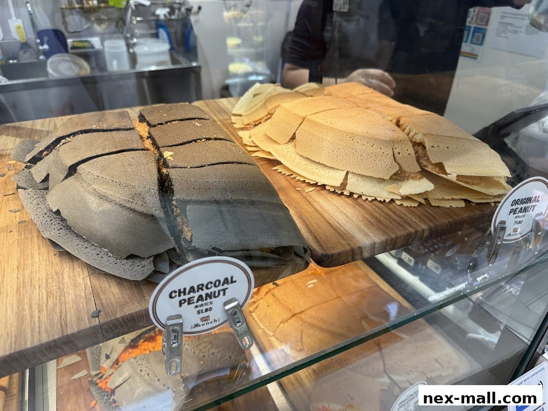 Close-up of charcoal and original peanut pancakes displayed in a shop window.