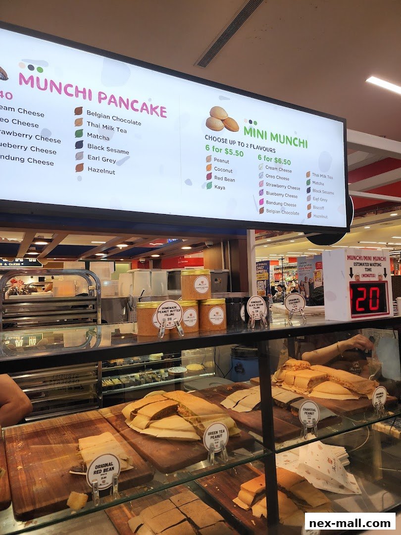 A brightly lit menu board displays various pancake and mini pancake flavors and prices.