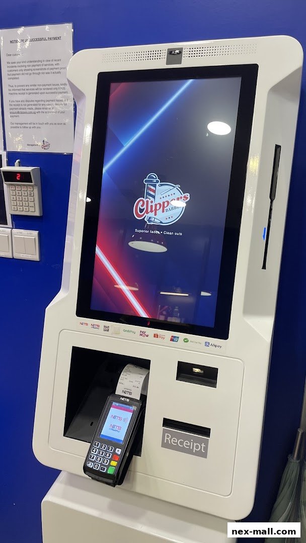 A payment kiosk for Clippers Barber with a receipt and card reader.