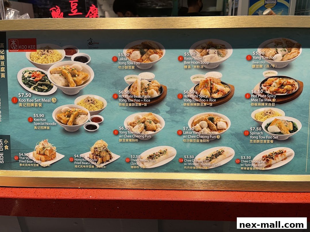 A menu board displaying various Yong Tow Foo dishes and side dishes from Koo Kee.