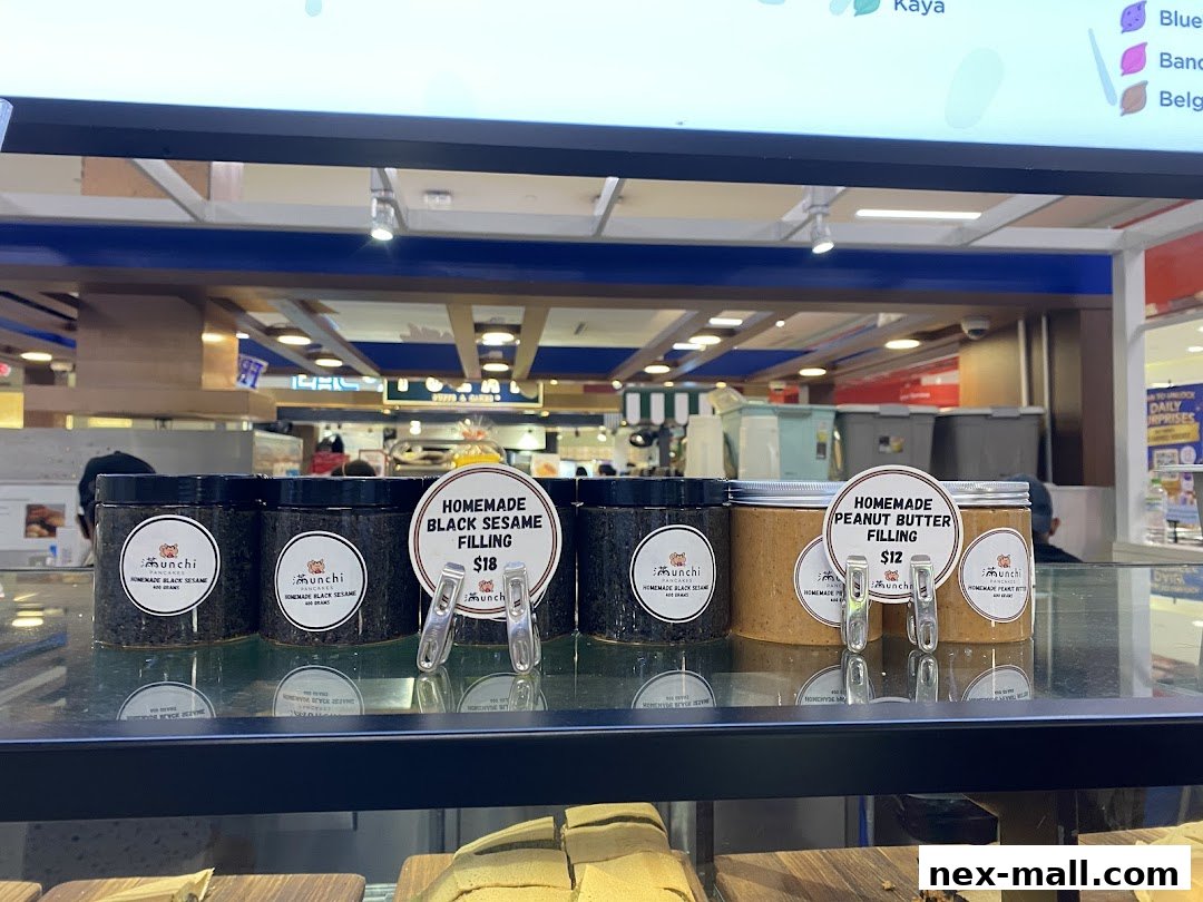 Jars of homemade black sesame and peanut butter fillings displayed at Munchi Pancakes.