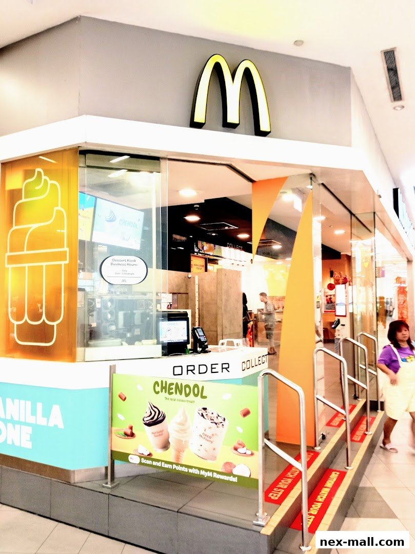 The entrance to a McDonald's dessert kiosk with prominent branding and promotional displays.