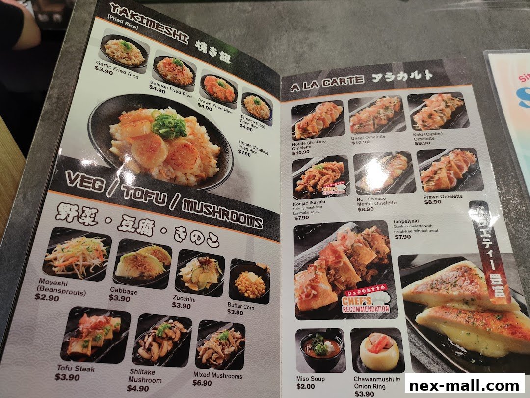 A menu from Yaki Yaki Bo NEX featuring various Japanese dishes like fried rice, omelettes, and vegetable options.
