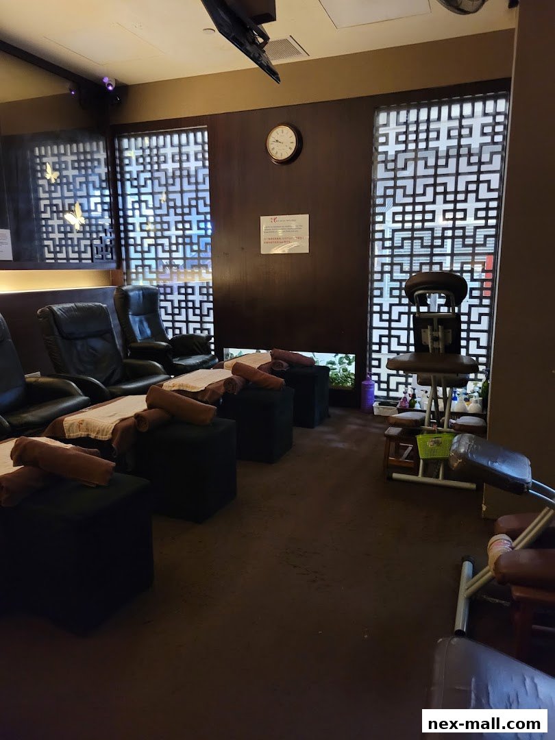 Interior of a wellness center with massage chairs and footrests.