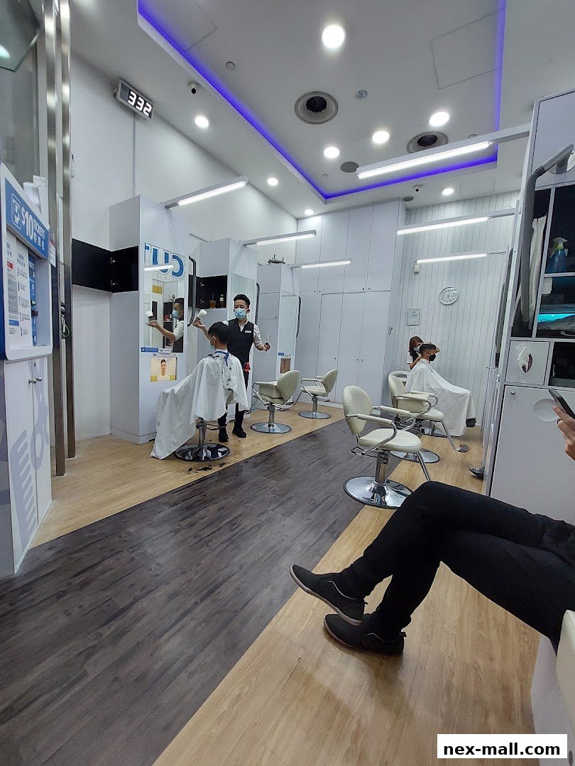 A modern hair salon interior with stylists attending to clients in chairs.