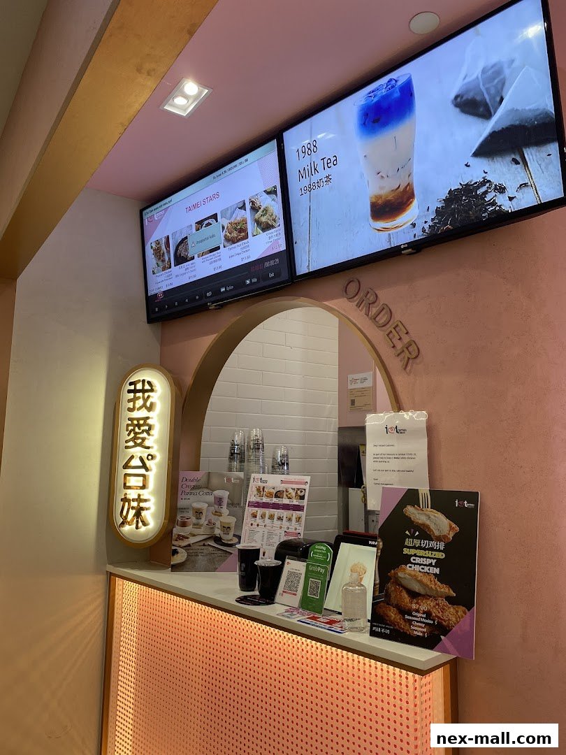 A counter display at "I Love Taimei" featuring drinks, crispy chicken, and promotional materials.