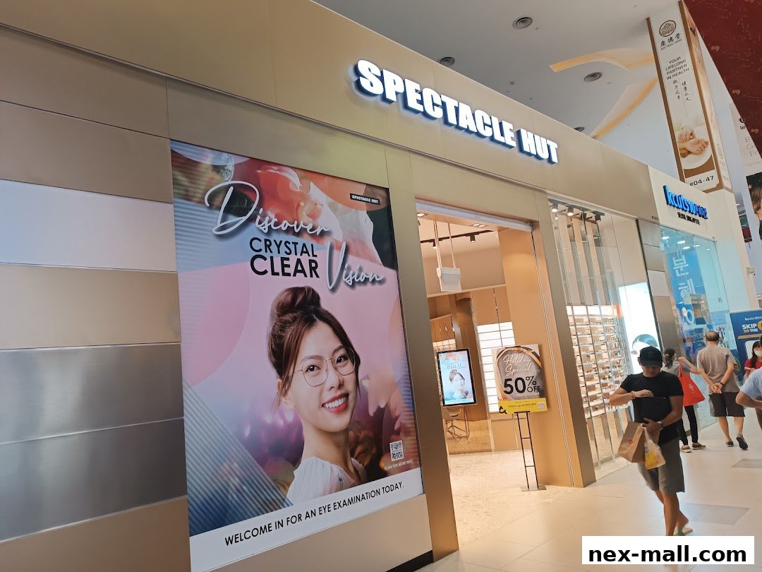 The exterior of Spectacle Hut, featuring a large advertisement for clear vision and an ongoing sale.
