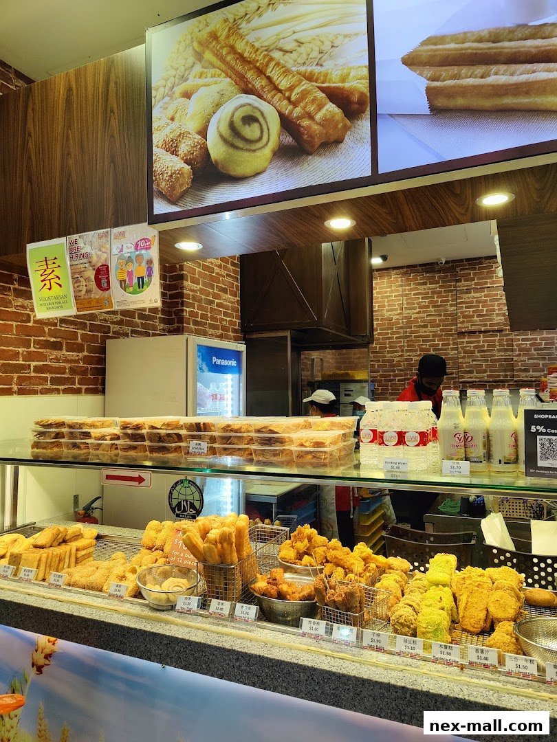 A display counter filled with various fried snacks and drinks at Dough Culture.