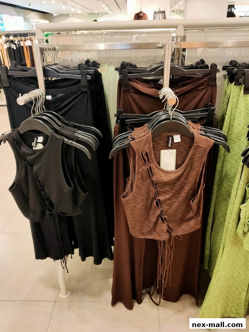 H&M store interior showcasing a selection of women's clothing, including tops and skirts.