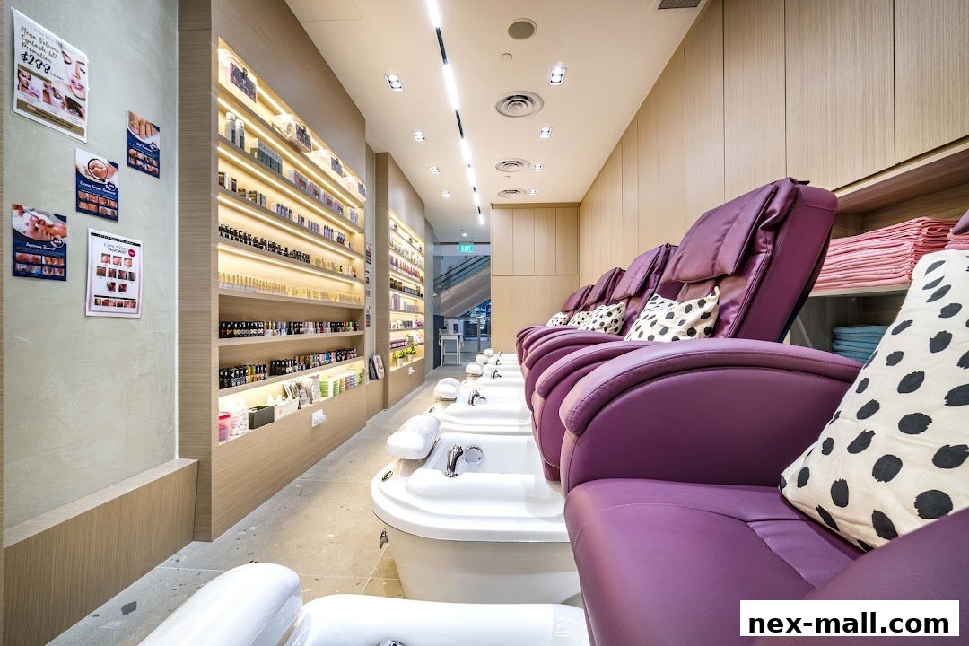 Interior of a nail spa with purple pedicure chairs and shelves stocked with nail polish.