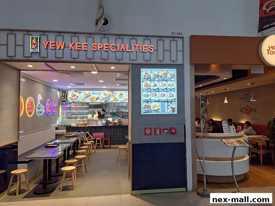 The exterior of Yew Kee Specialities restaurant, showcasing its dining area and menu display.
