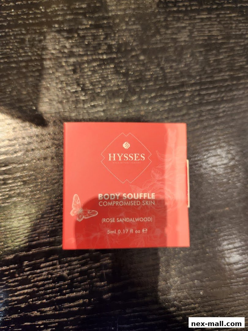 A small red box from HYSSES featuring 'Body Souffle' for compromised skin in Rose Sandalwood scent.
