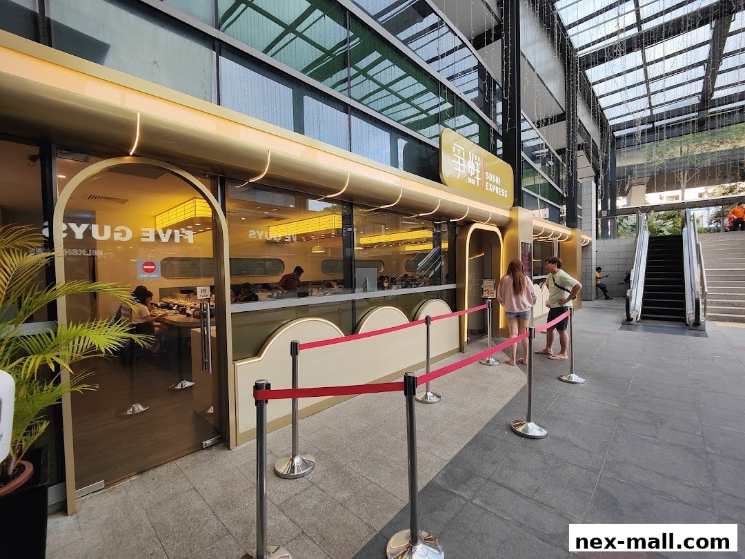 The exterior of a Sushi Express restaurant with people queuing outside.