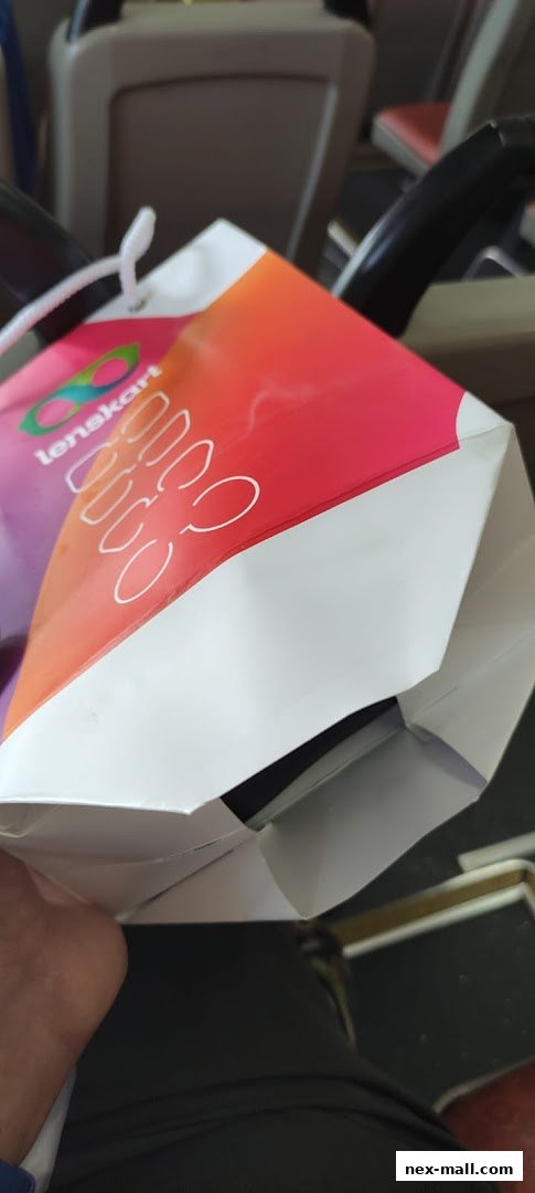 A Lenskart shopping bag with a colorful gradient design and the brand logo.