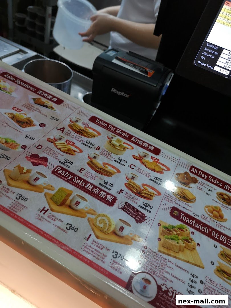 A close-up view of a menu board at Ya Kun Kaya Toast, showcasing various set meals and pastries.