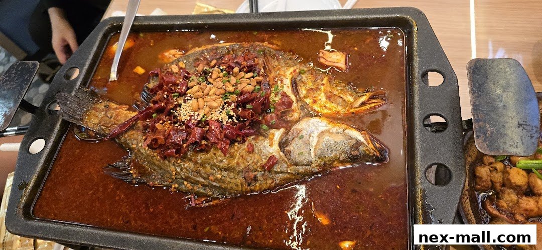 A whole fish cooked in a spicy broth with chili peppers and peanuts.