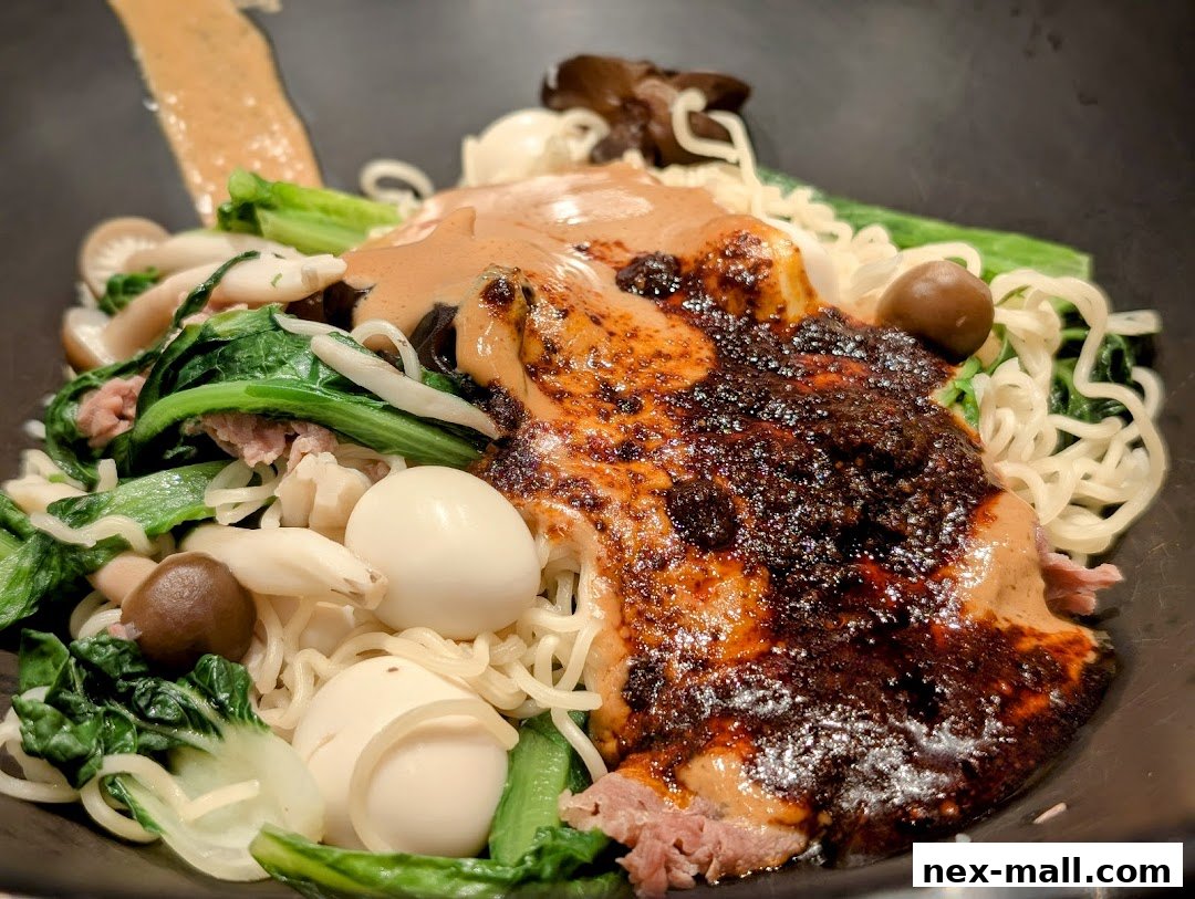 A close-up shot of a flavorful mala tang dish with noodles, vegetables, and quail eggs.