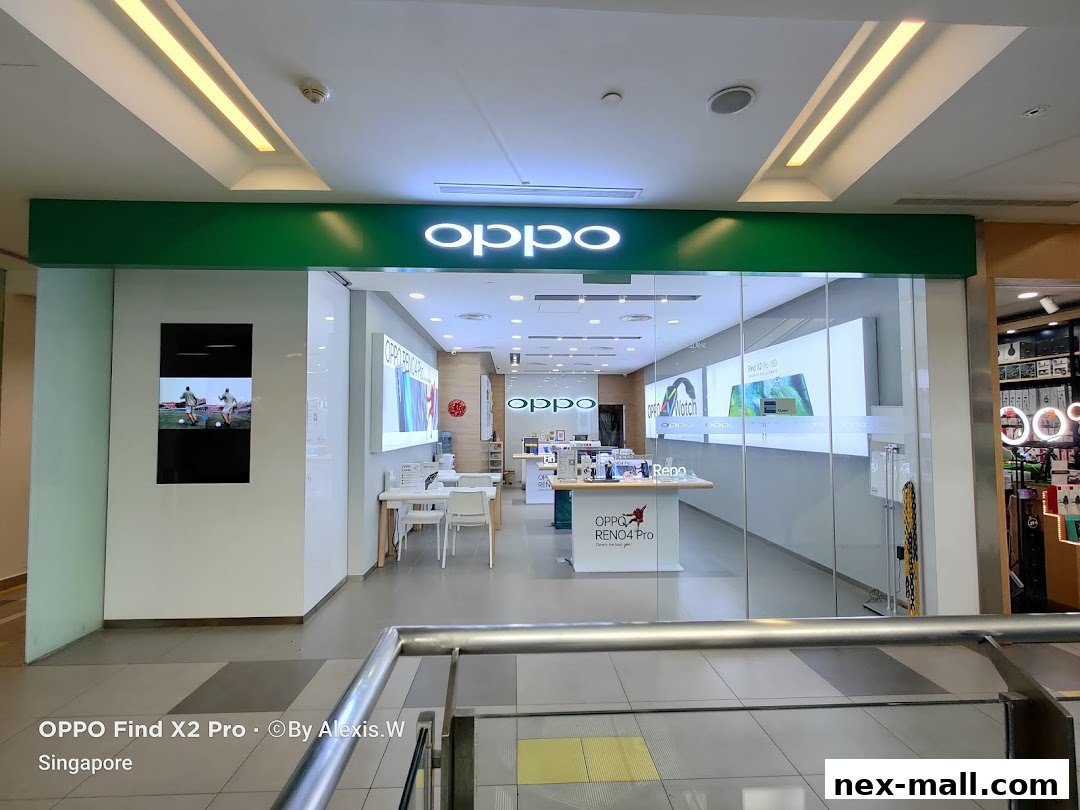 The exterior of the OPPO Concept Store with its prominent green signage and glass facade.