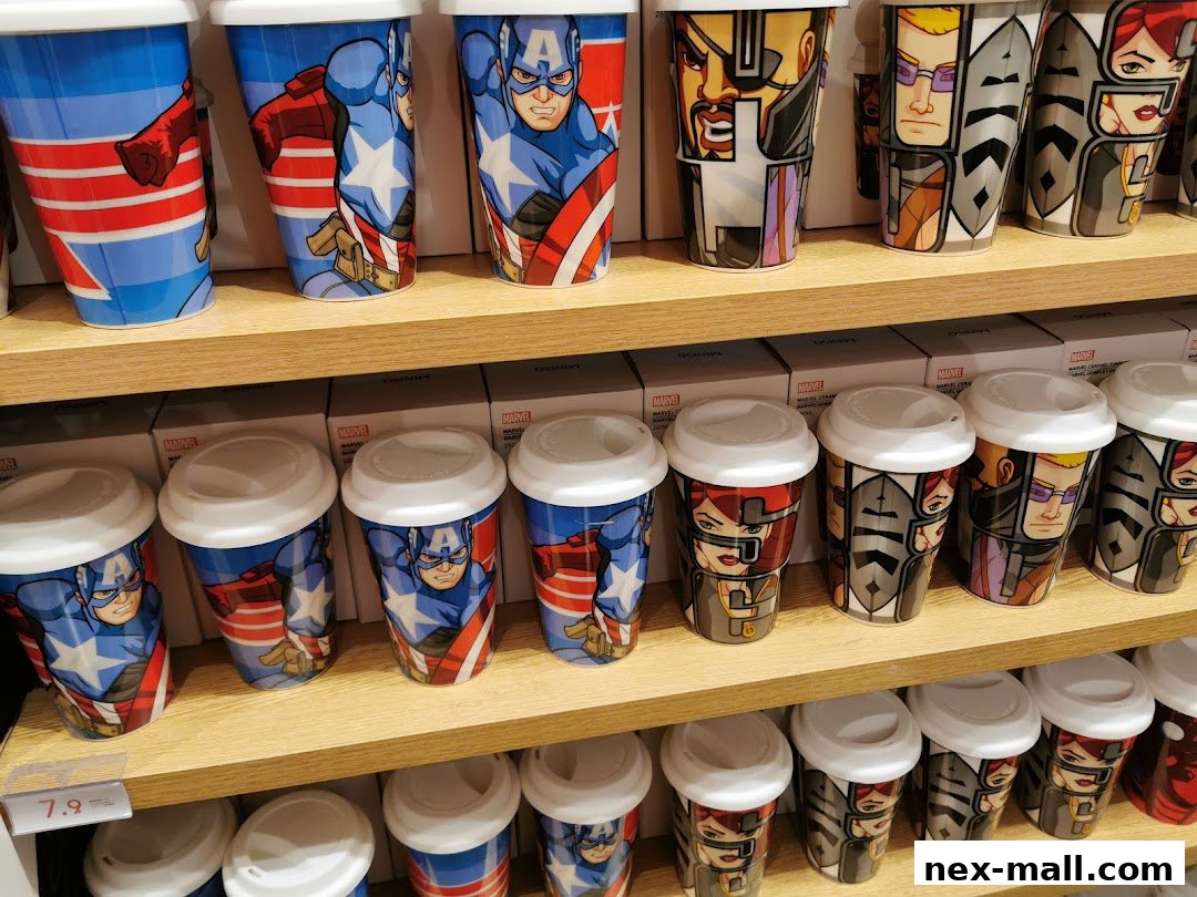 Shelves filled with Marvel-themed travel mugs featuring various superhero designs.
