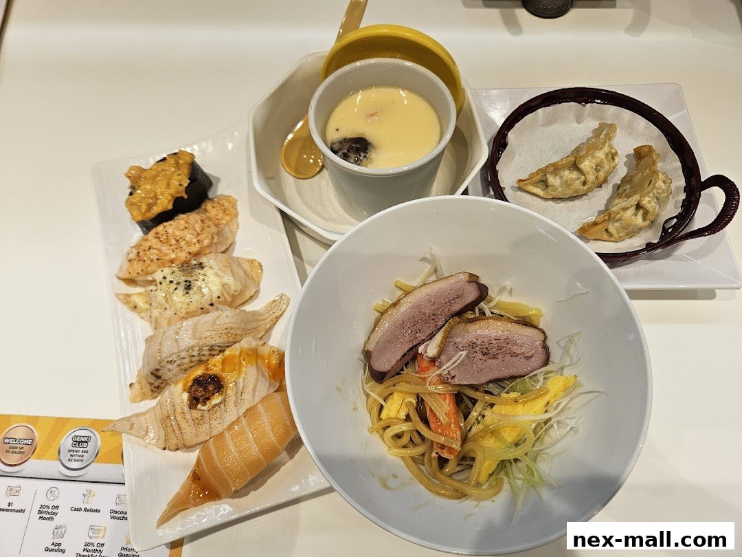 A selection of sushi, dumplings, chawanmushi, and a duck noodle dish.