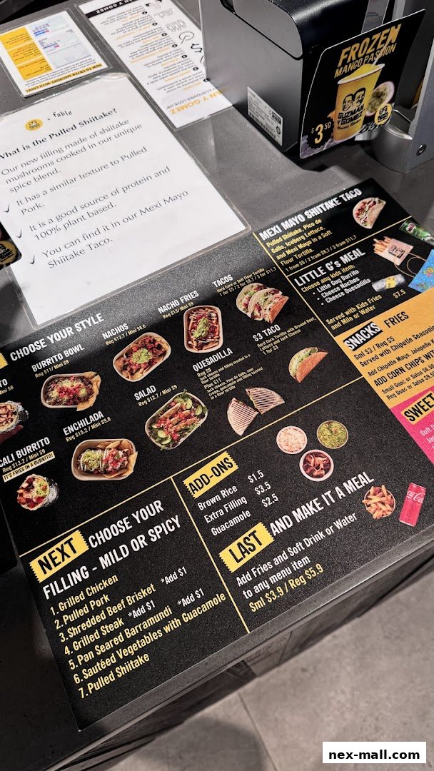 A close-up view of a Guzman y Gomez menu showcasing various meal options and fillings.