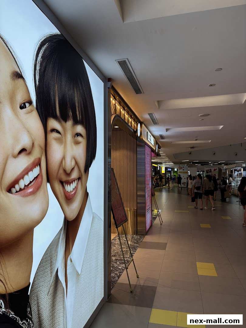 A brightly lit shop front with a large advertisement featuring two smiling women.