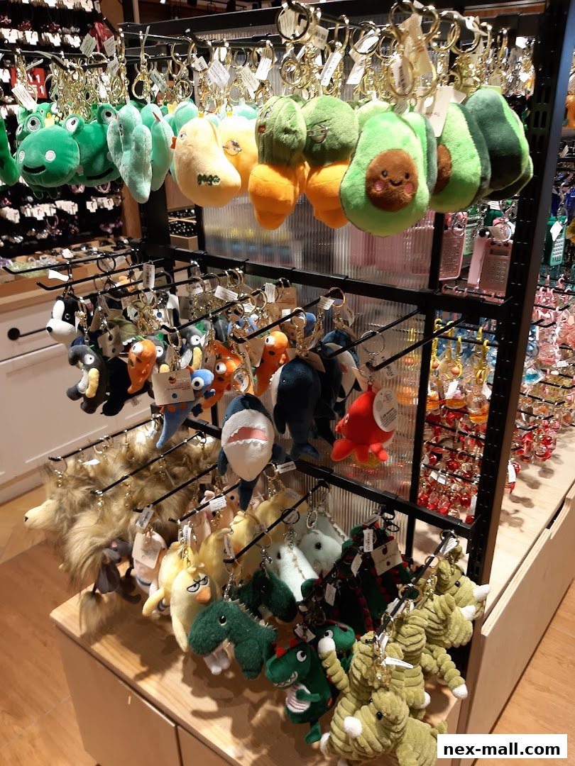 A display of various plush keychains including fruits, animals, and cartoon characters.