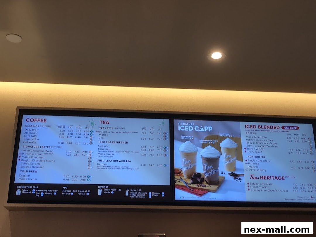A digital menu board displaying coffee and tea options with prices.