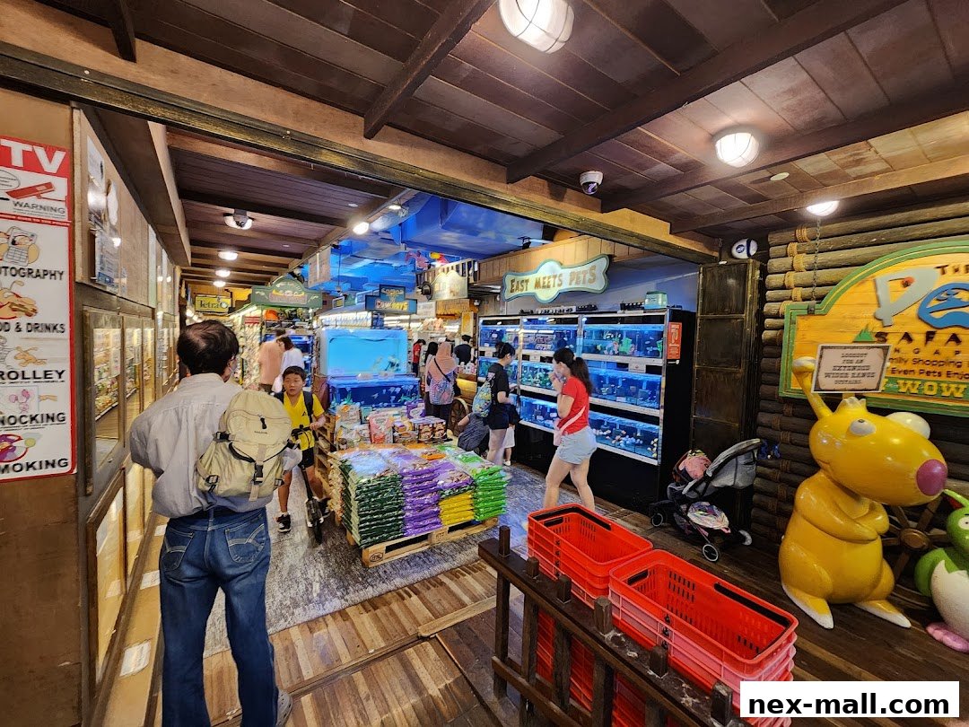 Interior view of a pet store with aquariums, pet supplies, and shoppers.