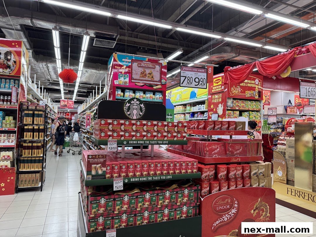 A supermarket aisle with displays of Starbucks coffee and Lindt chocolates, decorated for a festive occasion.