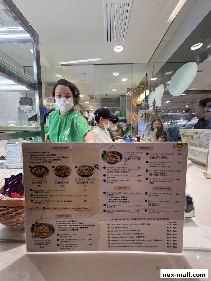 A menu board displaying various dumplings, noodles, side dishes, and beverages with prices.