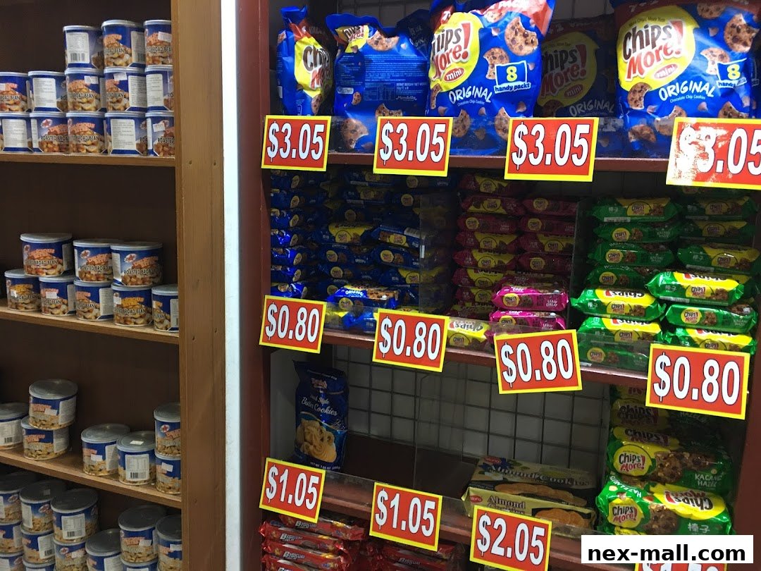 Shelves stocked with various snacks and canned goods, featuring prominent price tags.