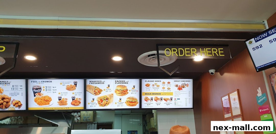 A menu board at Texas Chicken NEX displaying various chicken meals, sides, and drinks.