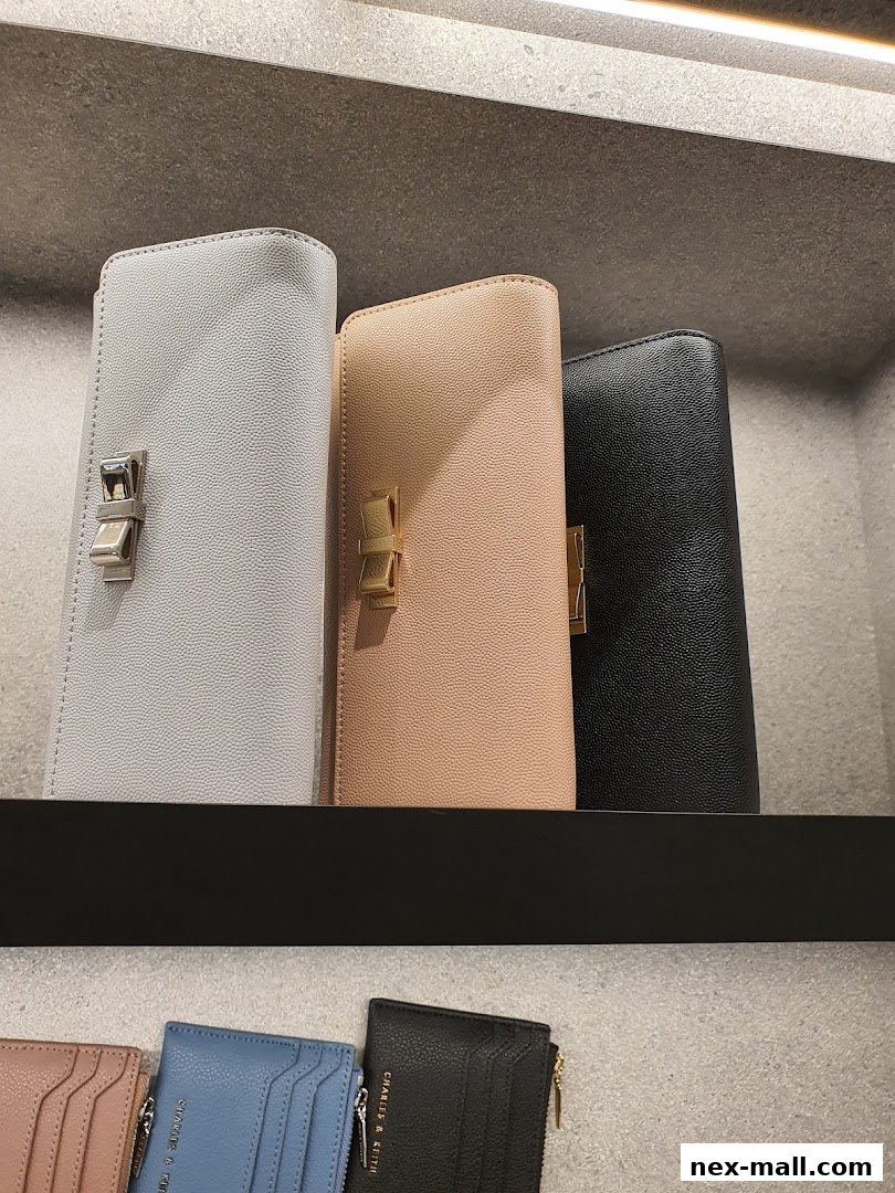 A display of Charles & Keith wallets and cardholders in various colors.
