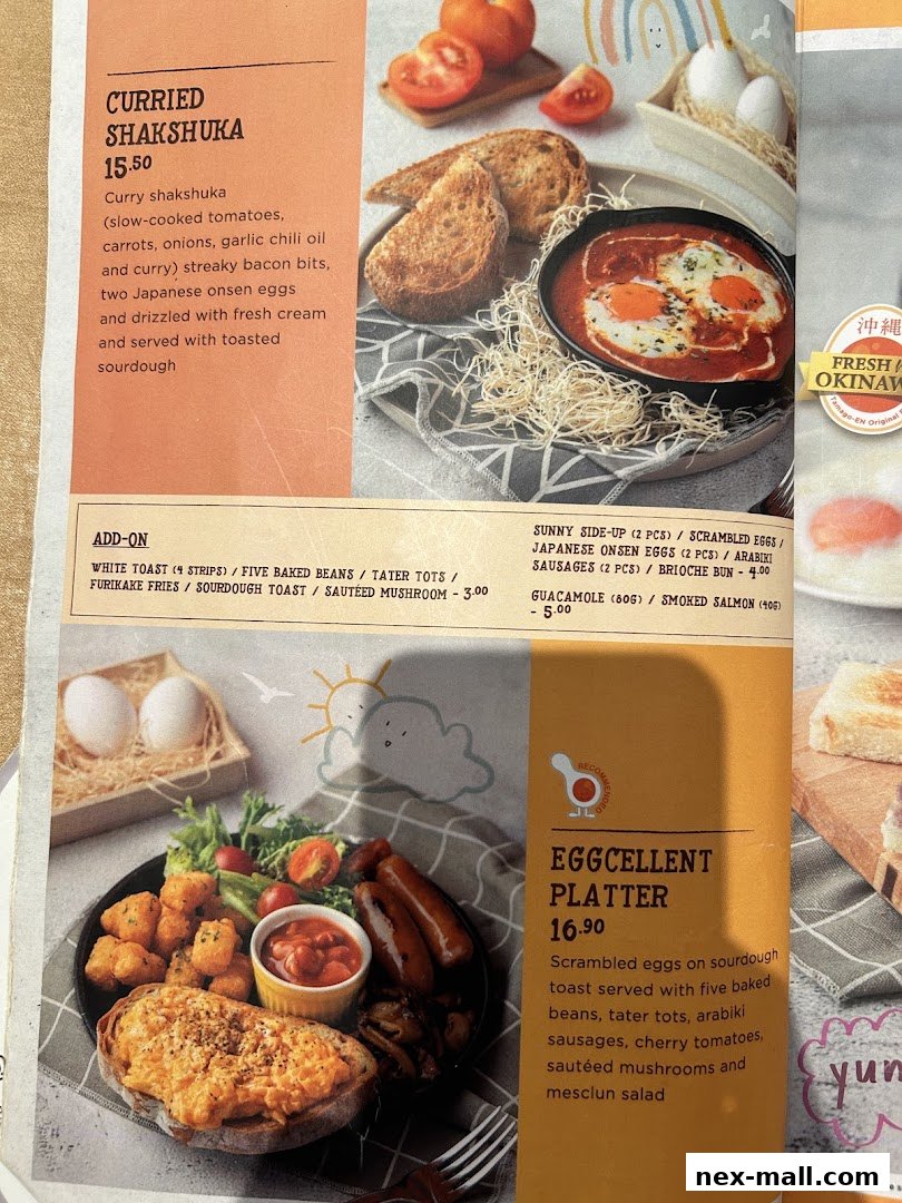 A menu featuring two breakfast dishes: Curried Shakshuka and Eggcellent Platter, with add-on options.