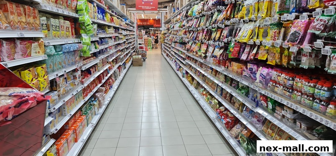 A wide aisle in a supermarket with shelves stocked with various snacks and food items.